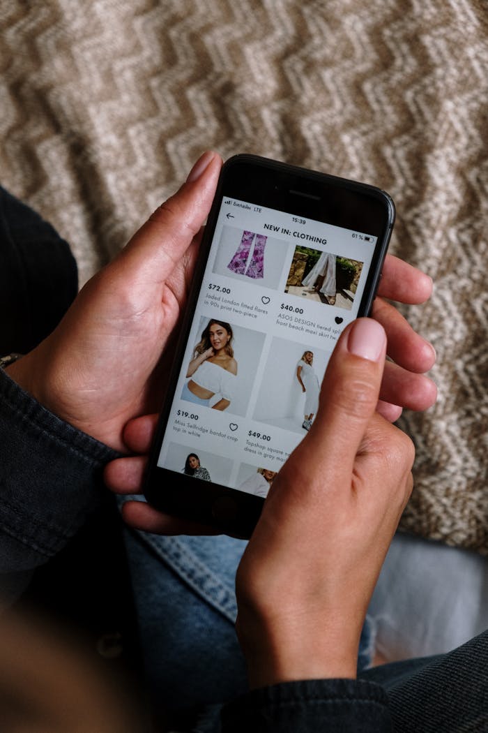 Close-up of a person shopping for clothing on a smartphone, highlighting the modern digital lifestyle.